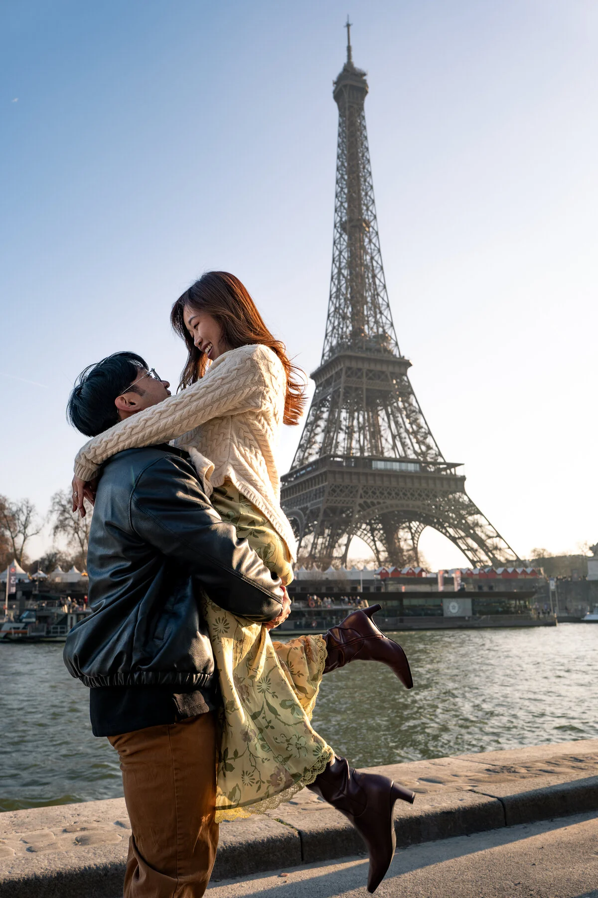 Couple in elegant outfits photographed at golden hour by the Seine, Paris