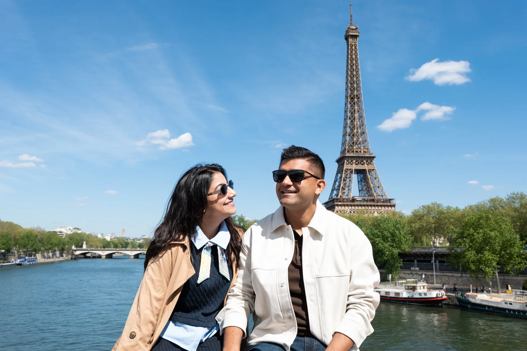 Couple with sunglasses by the Seine with the Eiffel Tower, Paris