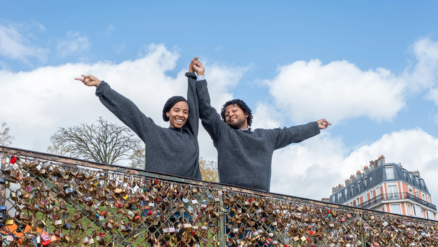 Couple celebrating on Pont des Arts with love locks in Paris